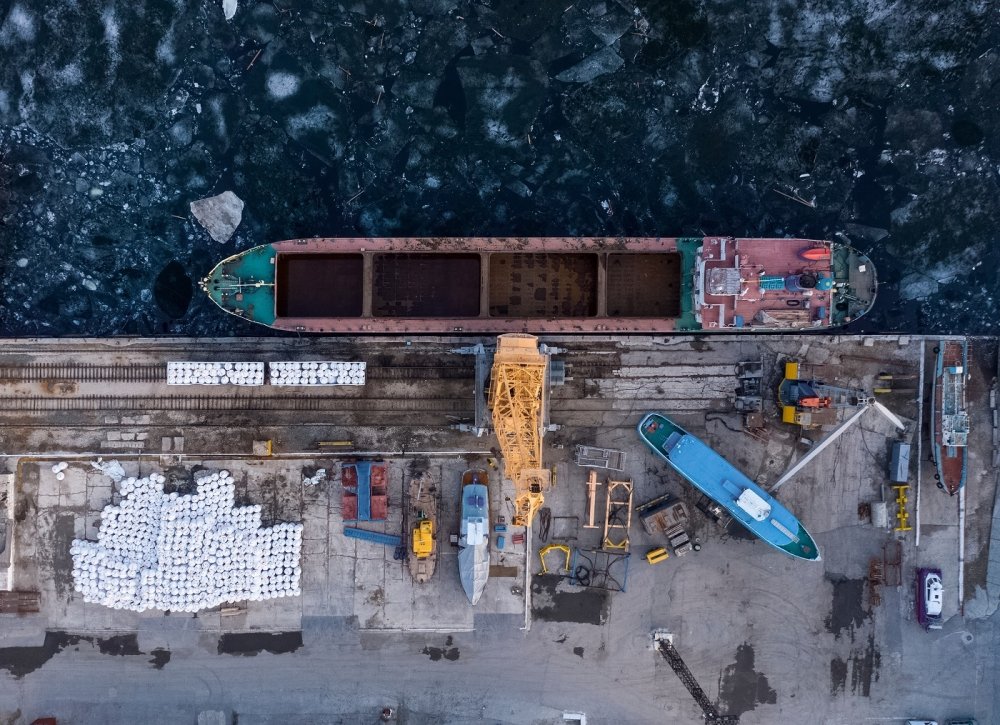 Aerial view from above of the river port with gantry cranes. Cranes in the cargo port of Togliatti in winter.