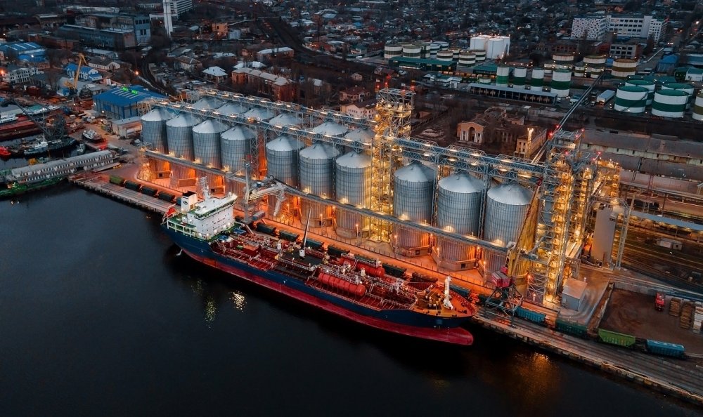 Ship at port next to large grain elevators