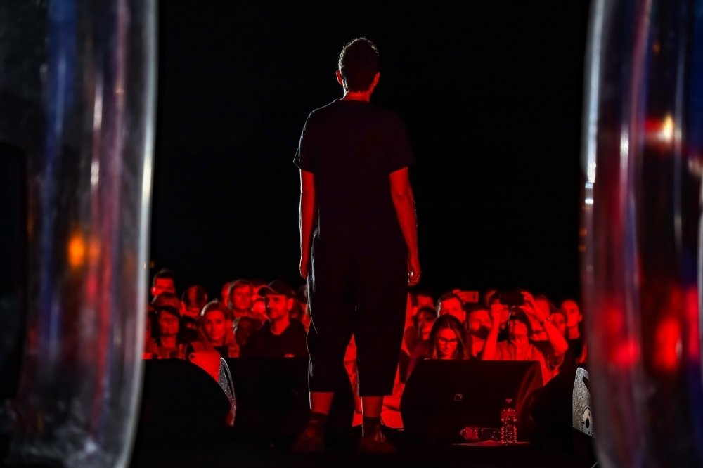Image of person on stage with audience in the background 