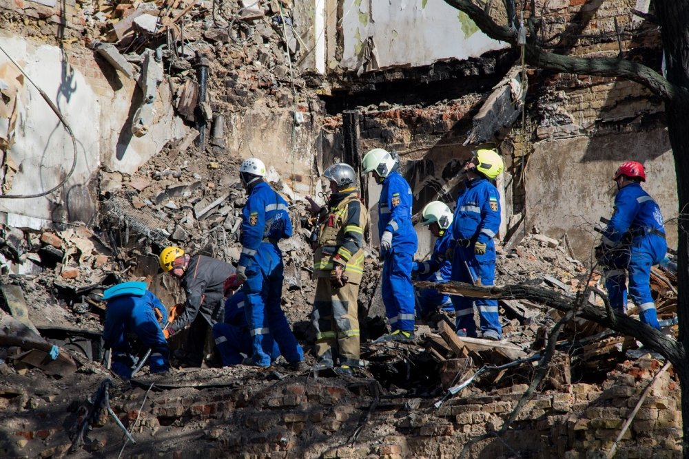 Rescuers are searching for people under the rubble of a collapsed house in Kyiv after a drone attack