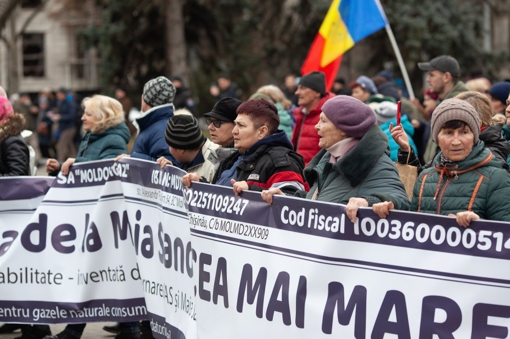 Group of protesters holding long banner