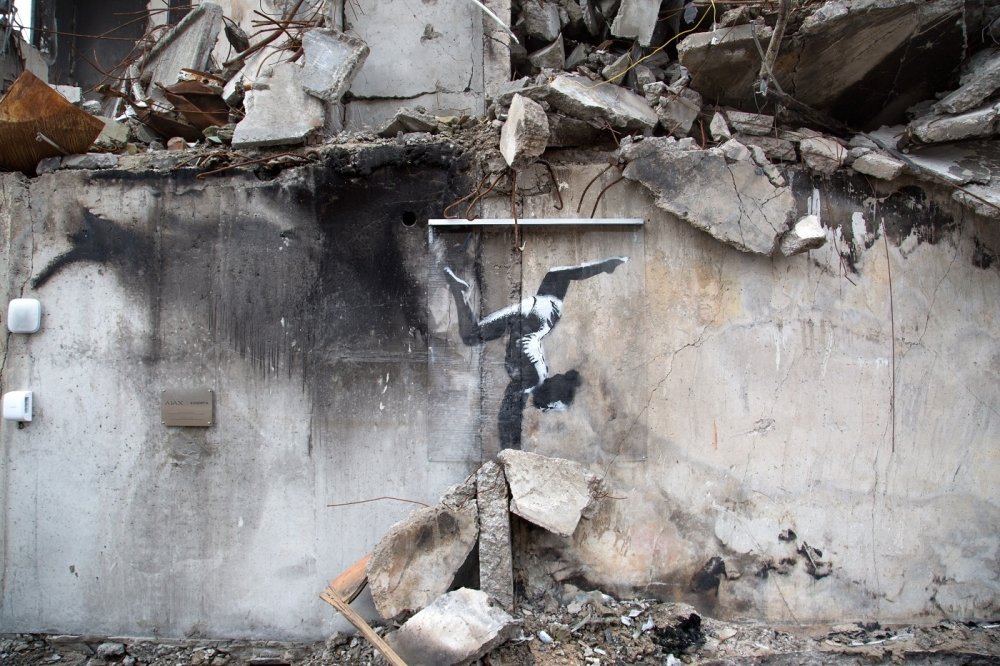 Graffiti art of a gymnast in rubble