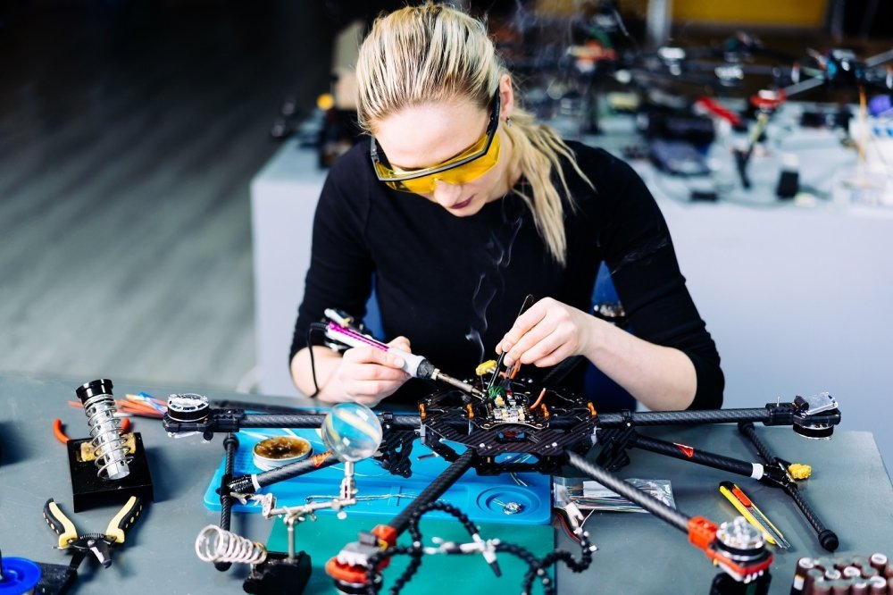 A woman engineer working on a racing drone.