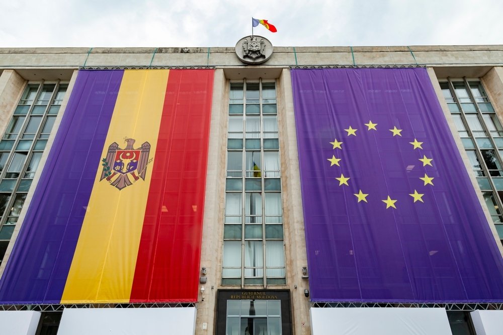 Large flags of Moldova and the European Union on the building of the government of Moldova on the eve of the summit of the European Political Community