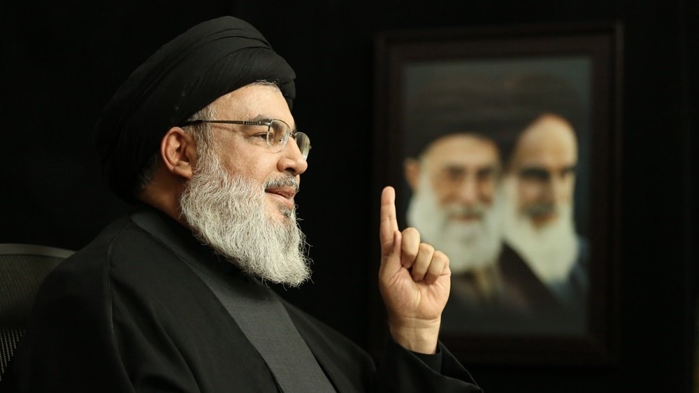 Nasrallah with Khamenei and Khomeini photo