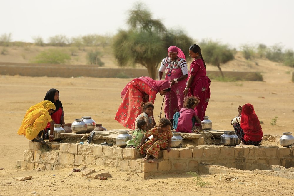 Women drawing water from a well