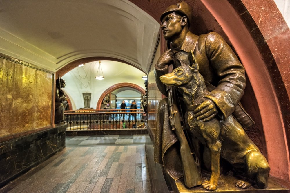 A Soviet border guard and his dog (1938) at the Revolution Square subway station in Moscow.