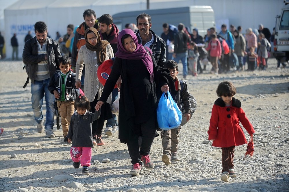 Refugees and migrants moving towards the railway station in Gevgelija.