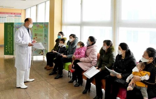 A doctor speaking with patients in North Korea.