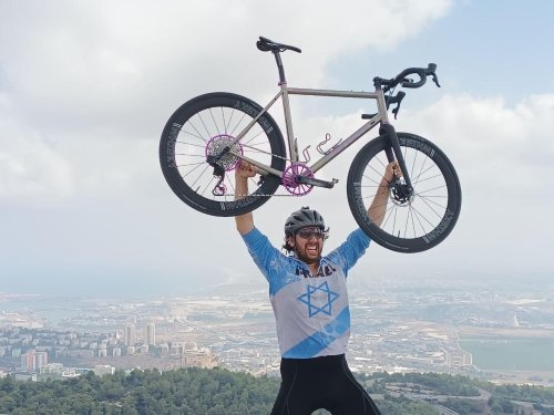 Man holding bike above his head