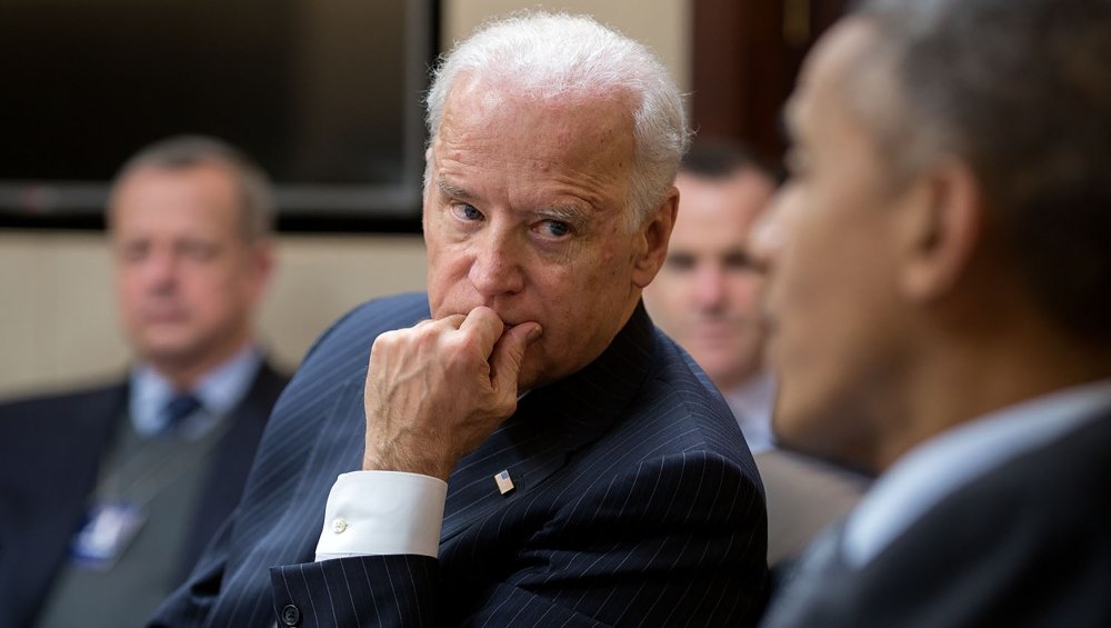 A picture of Joe Biden listening to President Obama speaking.