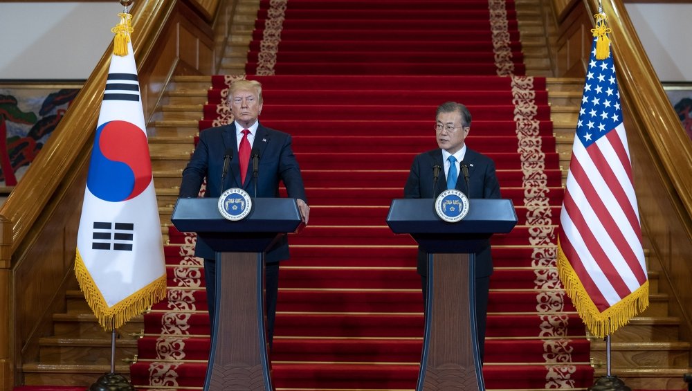 President Donald Trump and President Moon Jae-In stand at podiums during a press conference.