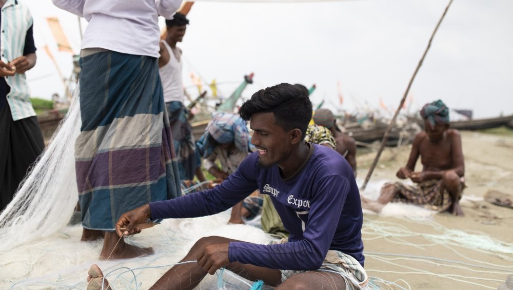 Bhola island fishermen repairing their nets