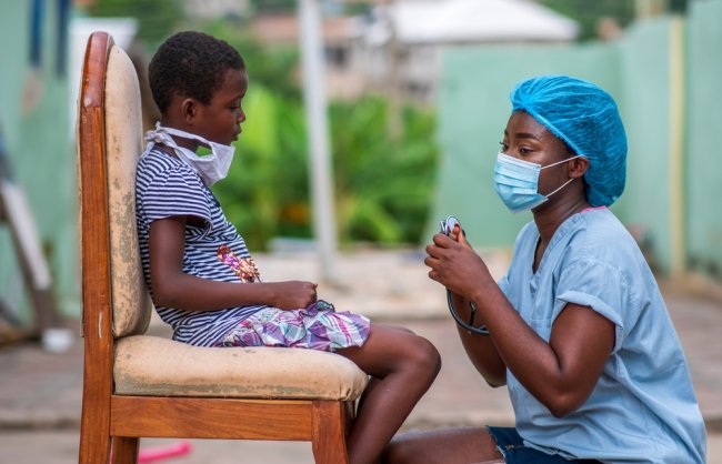 African Healthcare Worker and Child