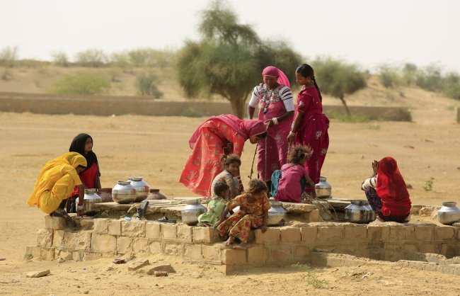 Women drawing water from a well