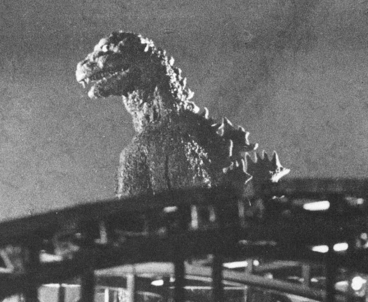 A behind the scenes shot of the 1954 Tōhō film Gojira, showing the original Godzilla as an ancient radiation-breathing monster awakened by the hydrogen bomb. Released months after the Lucky Dragon accident during the Castle Bravo test, the movie spoke to Japan's victimization by nuclear weapons." Source: Wikimedia Commons.