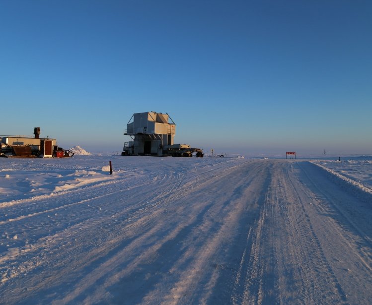 Snow road with a substructure of the oil work over rig and a distant view of the drilling rig at an oilfield in the tundra in winter. Source: Shutterstock