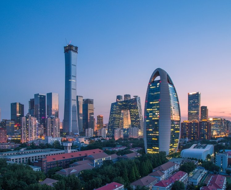 A photo of the Beijing skyline at dusk.