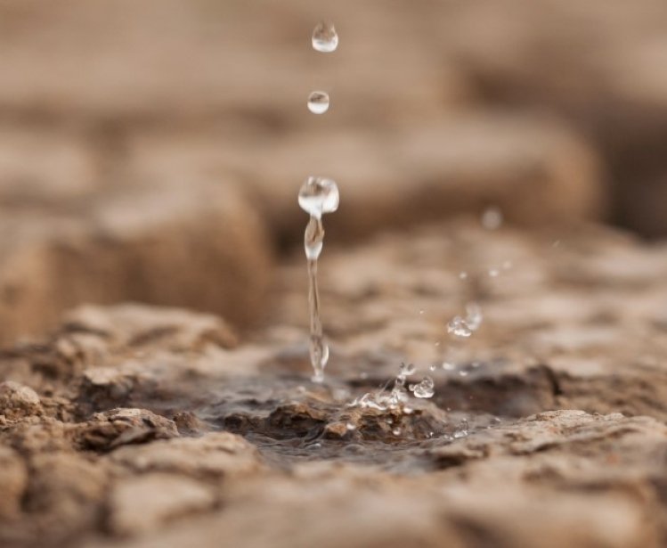 Water drop on dry cracked land