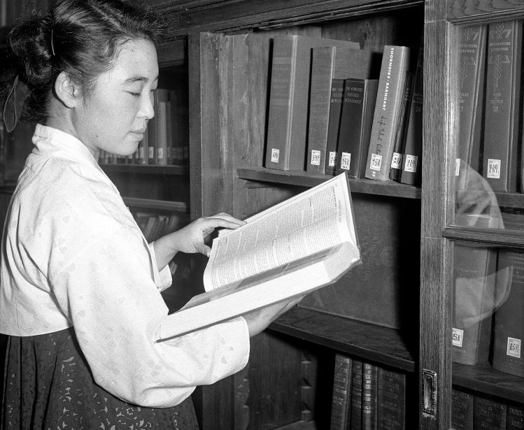 A student doing research in the library of Ewha Women's University in Seoul. 01 September 1954. 