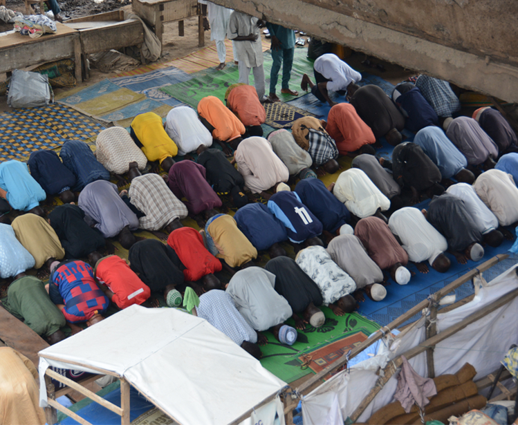 Muslim faithfuls praying under a bridge in Lagos, Nigeria