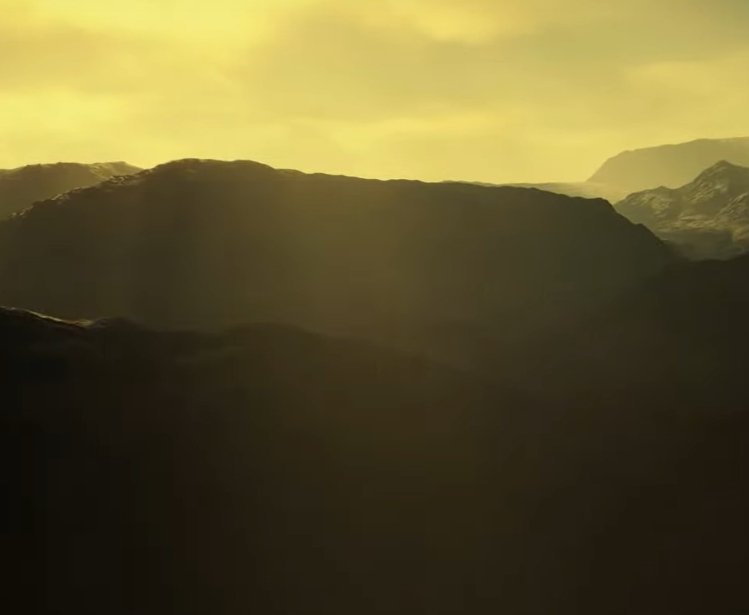 An image of mountains with a yellow sky