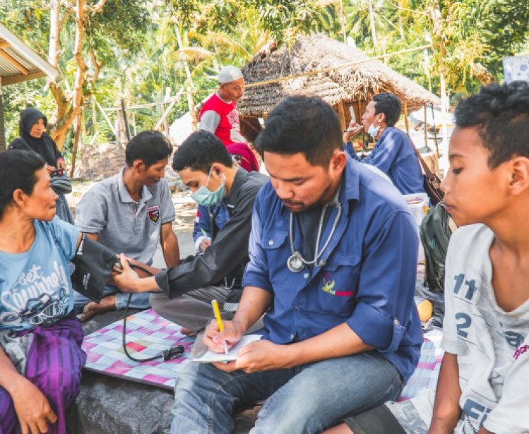 Group of health and aid workers treating patients
