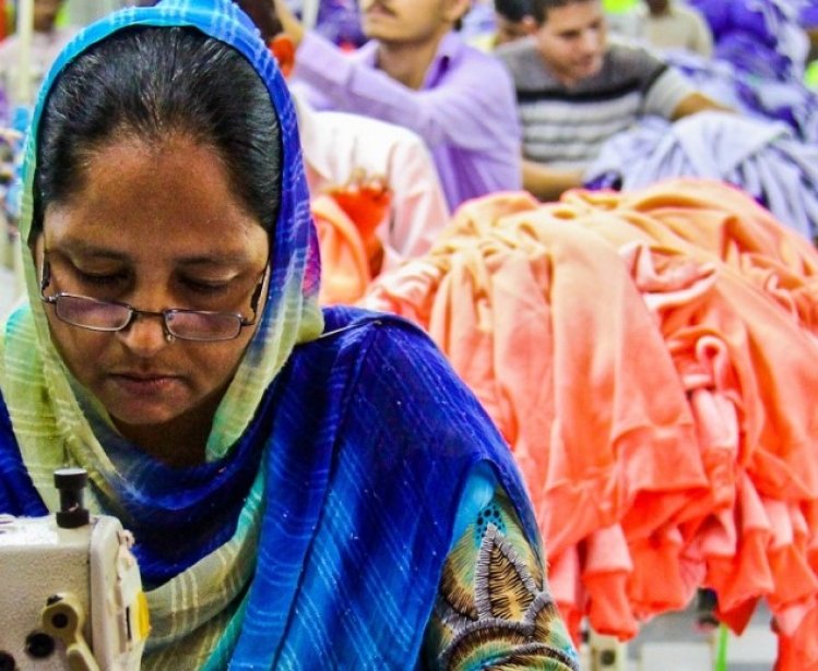 A woman worker manufactures a garment in a project benificiary factory - women constuitute a significant portion of the workforce in Pakistan's garment industry