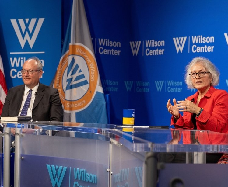 Marie Yovanovitch sits in front of Wilson Center branding