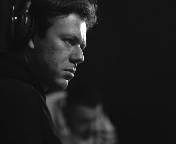 Black and white photo of man in profile wearing headphones