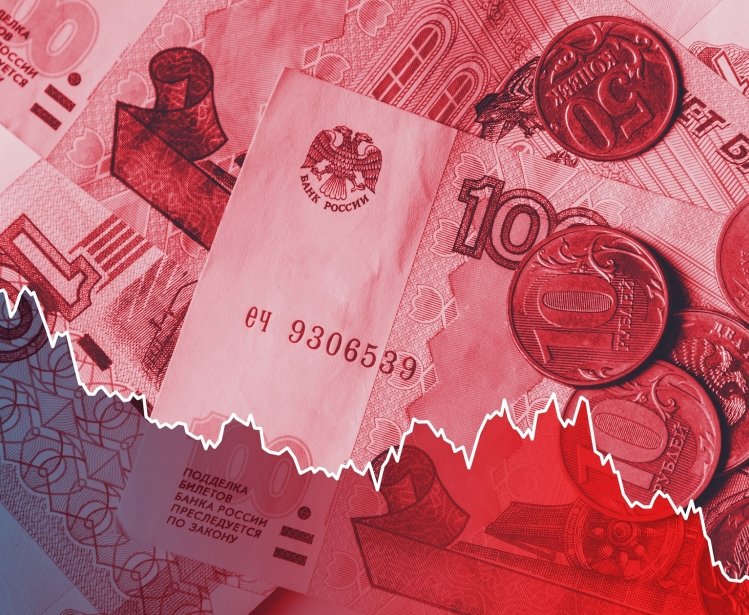 A line graph indicating the ruble's plummeting value overlays a close-up shot of ruble notes and coins.