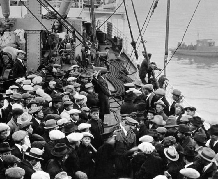 Public health workers process immigrants arriving to the United States at Ellis Island in 1891.