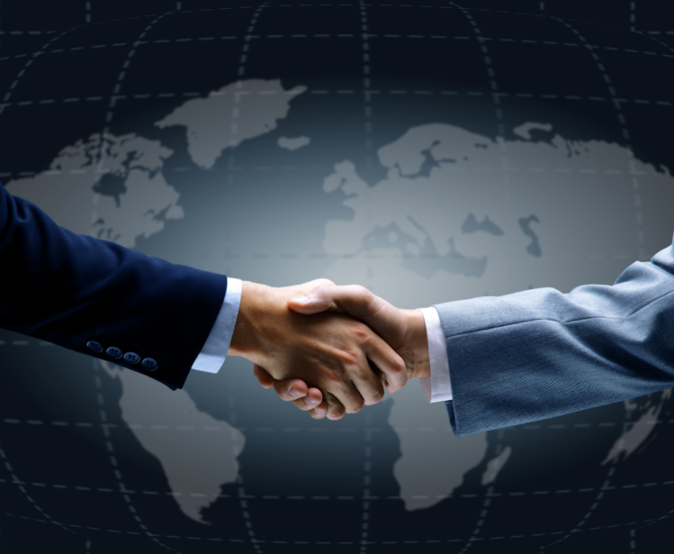 Handshake in front of world map