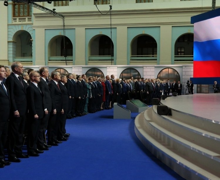 Putin on stage addressing the Federal Assembly of Russia