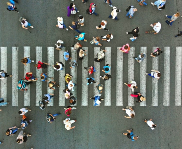 Aerial view of pedestrians passing a crosswalk during rush hour