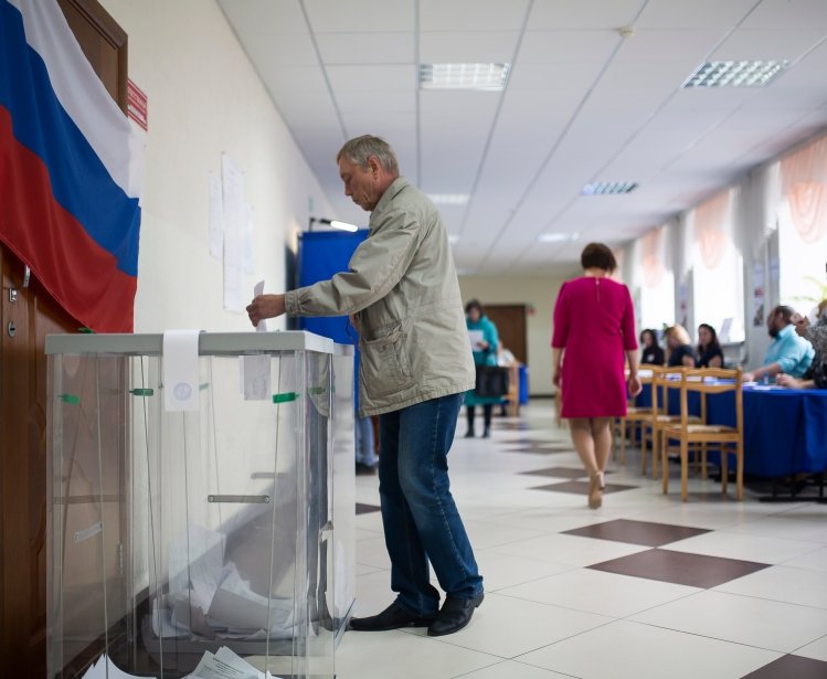 Tyumen, 2018: Photo of a man casting a ballot in a Russian eleciton