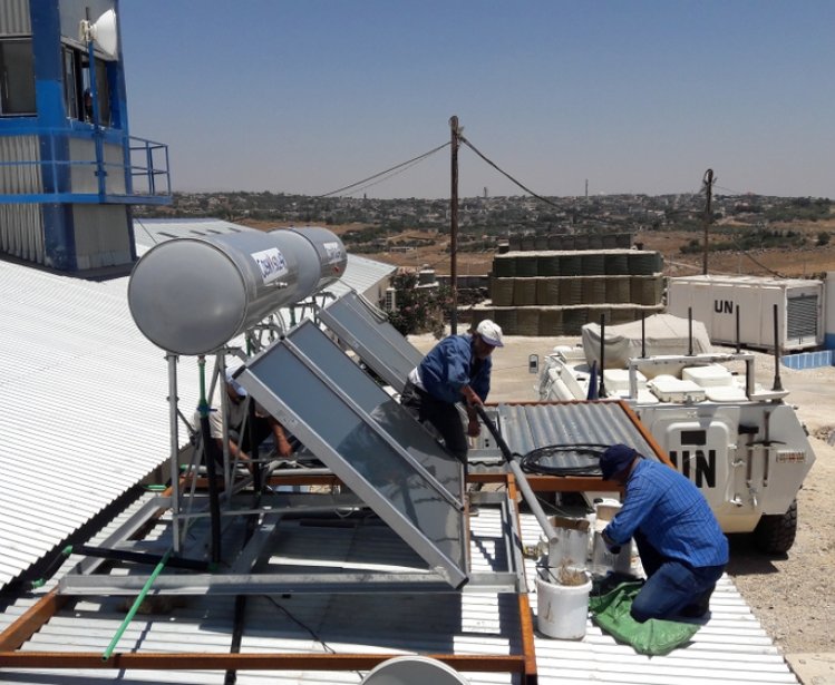 Workers installing solar power unit