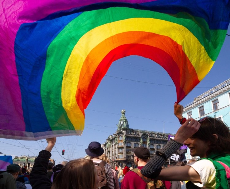 Saint-Petersburg, Russia - May 01, 2019: May demonstration. Marchers with a rainbow LGBT flag on Nevsky prospect.