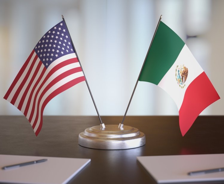 USA and Mexican flags on table