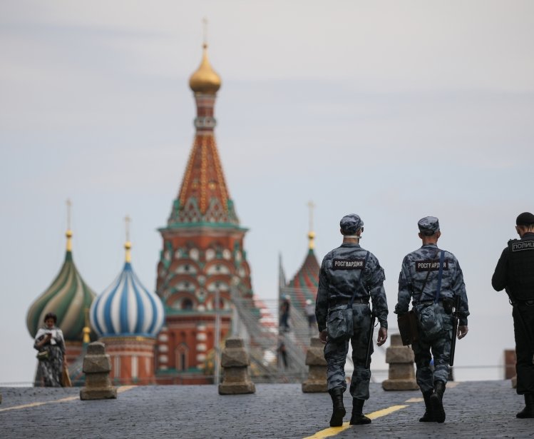 Russian police officers walk across Red Square.