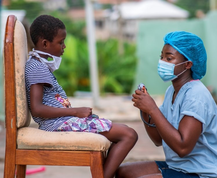 African Healthcare Worker and Child