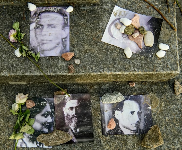 Portraits of killed Jews near Menorah monument in Memory of Jews Victims at the Babyn Yar National Historical Memorial. October 2020 Kyiv, Ukraine.