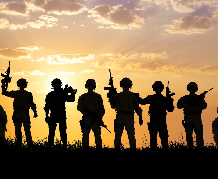 silhouette of Soldiers team with sunrise background