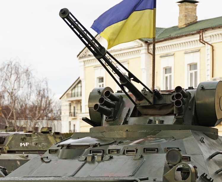 Army troops transporter and tank with Ukrainian flag, Ukraine