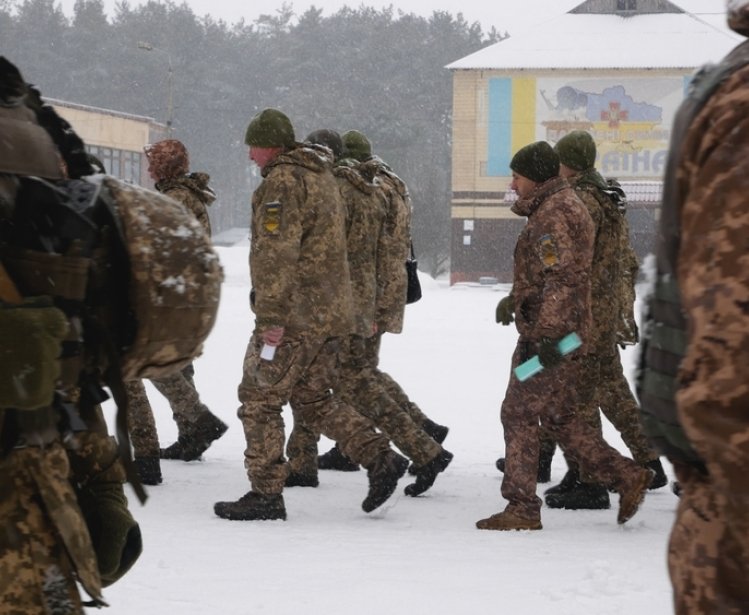 Kharkiv, Ukraine - January, 31, 2022: Many Ukrainian soldiers in camouflage uniforms march in formation. Ukrainian army prepares for Russian invasion