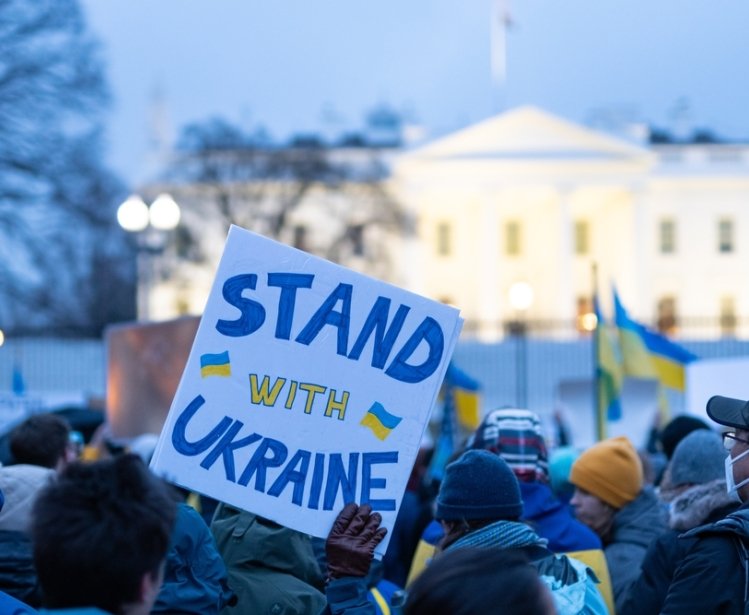 Washington DC, USA- February 24th, 2022: Anti-war Protesters holding pro-Ukraine signs outside the White House after Russia invaded Ukraine.