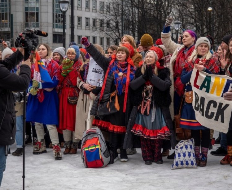 The Sami people, and others, holding a demonstration against the government because of the windmills being built on their land.