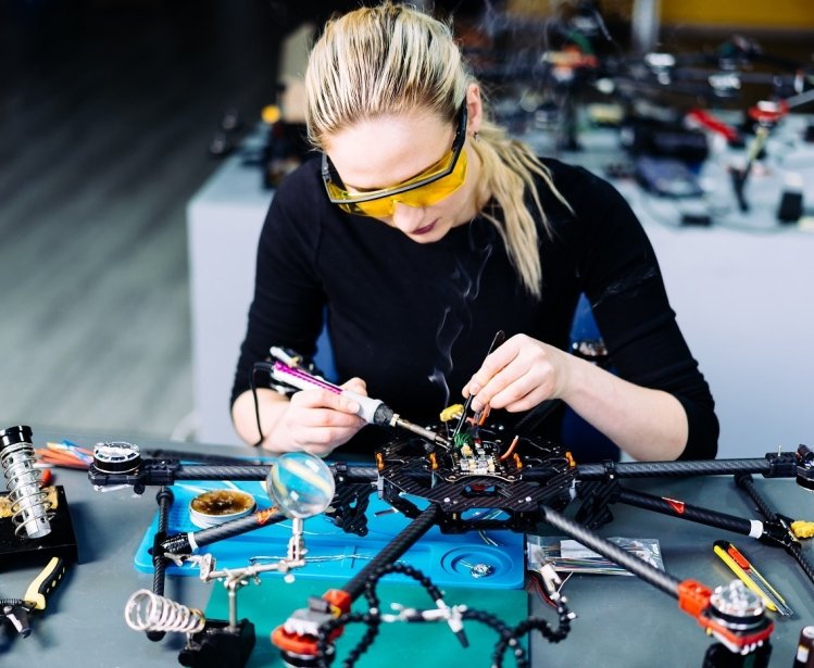 A woman engineer working on a racing drone.
