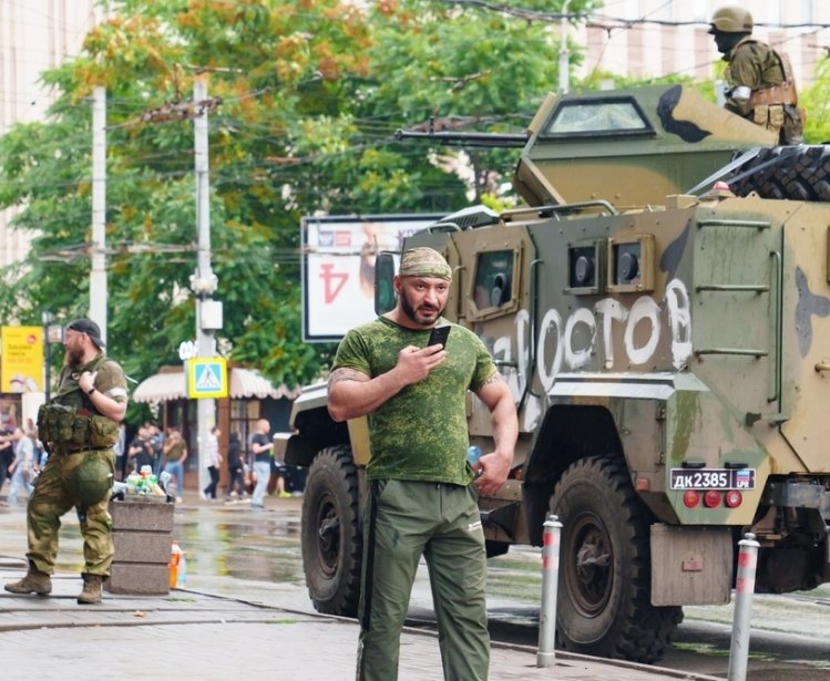 Man next to tank in city street