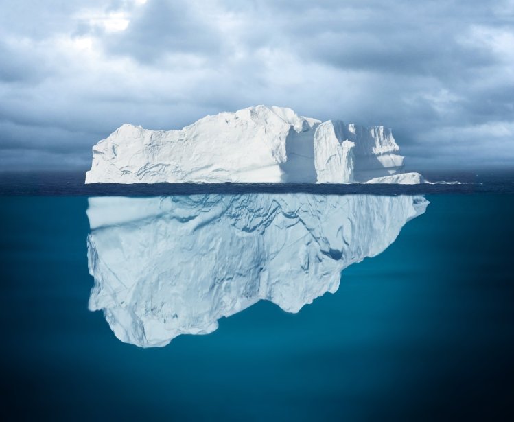 Iceberg Mostly Underwater Floating in Ocean